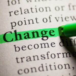 Person highlighting the word ‘change’ in a dictionary, symbolising legal name change.