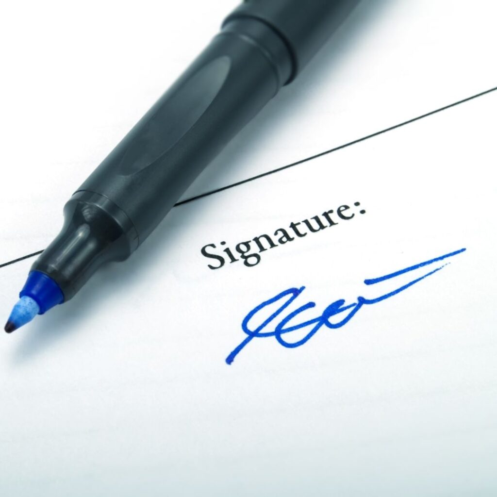 Person signing deed poll documents for an official name change.