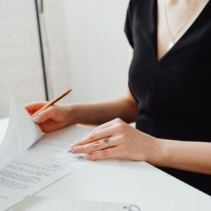 Adult signing a deed poll document to legally change their name in the UK.